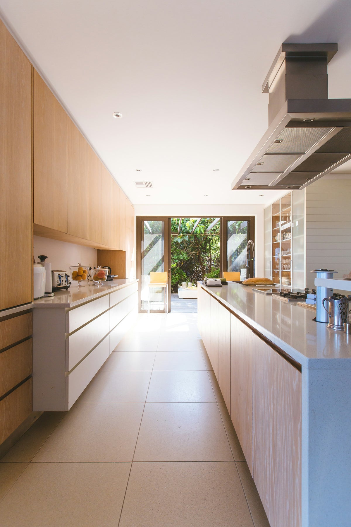 White kitchen island and cabinets near a glass door