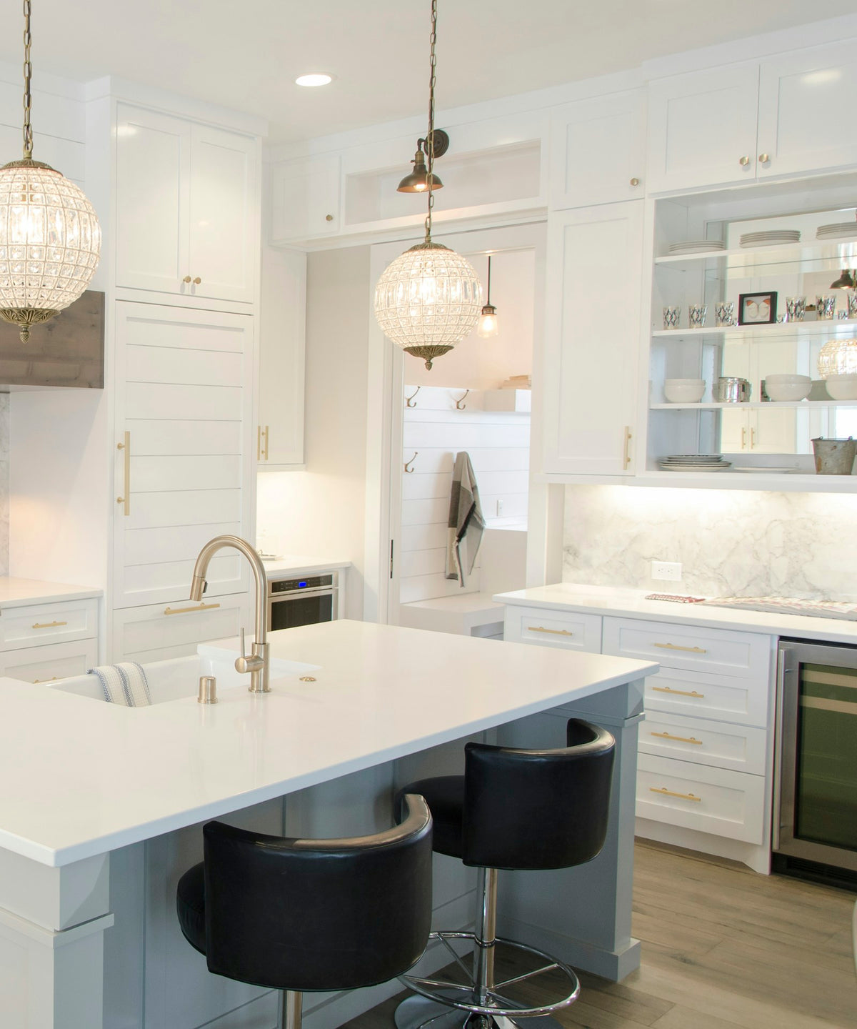 White kitchen cabinetry with gold pendant lights