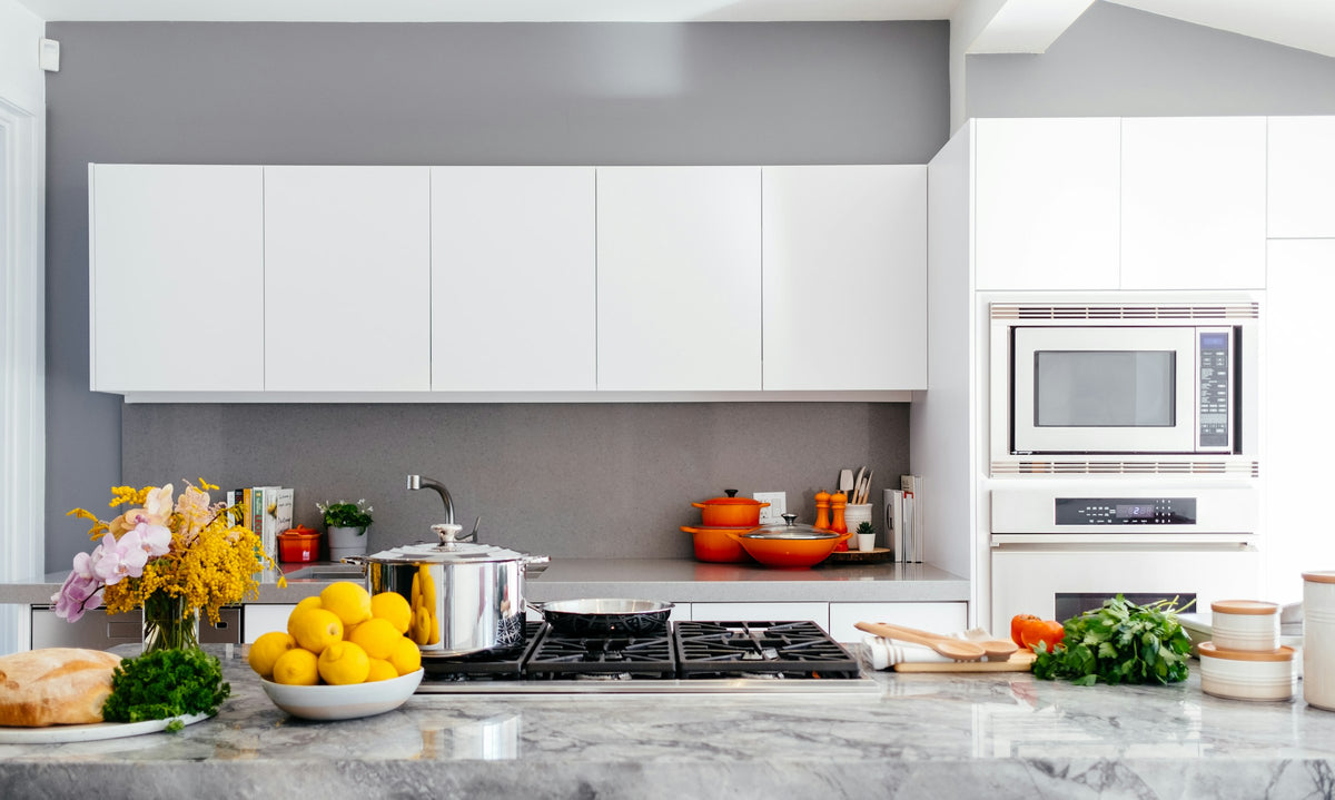White kitchen with a marble island