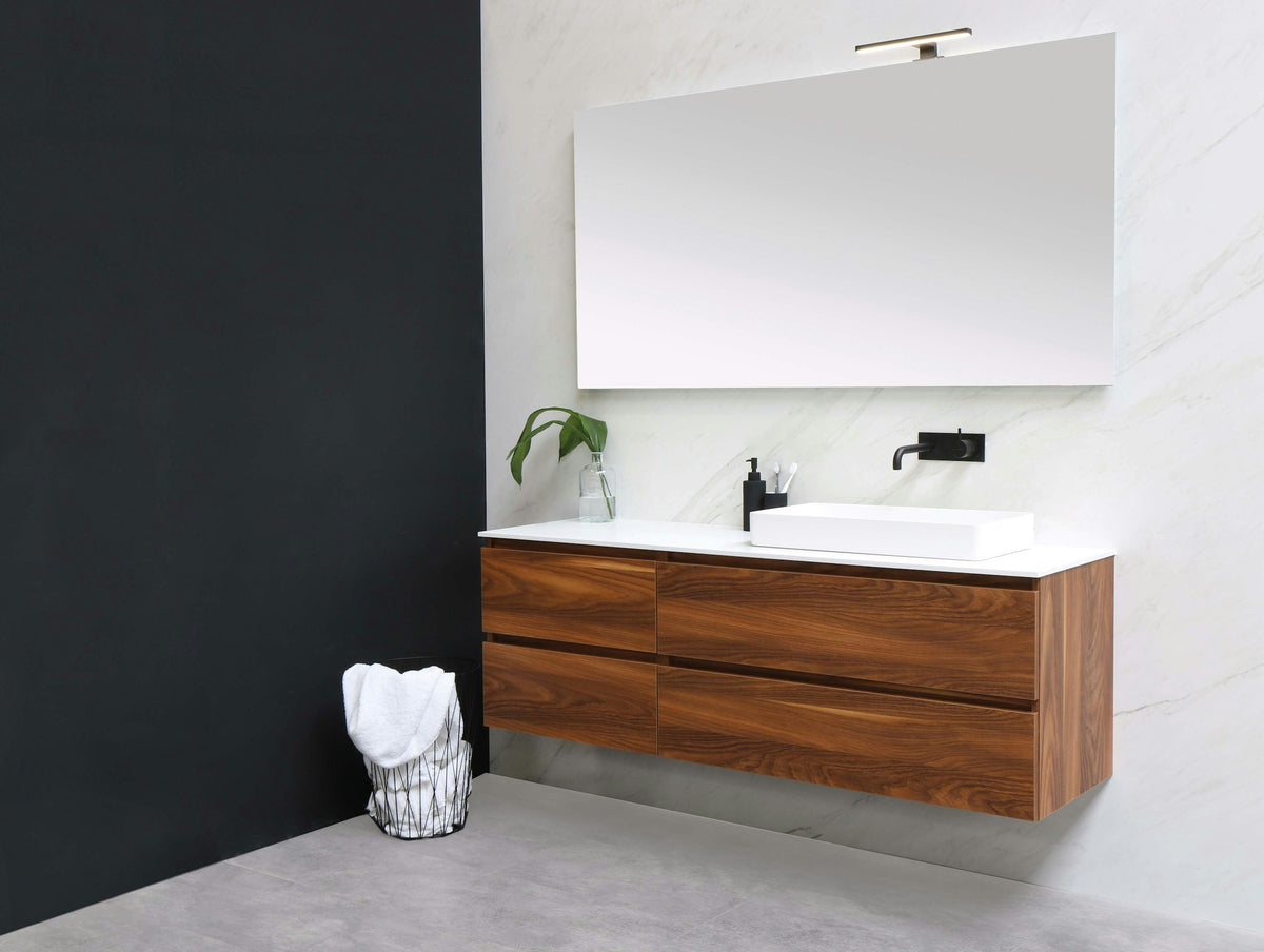White sink on a wood vanity cabinet