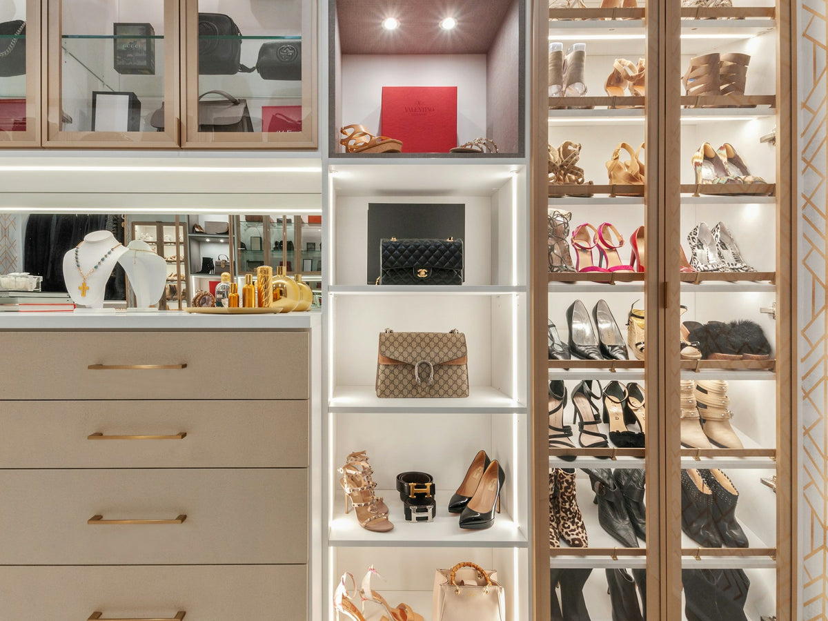 Custom closet with white shelving for shoes and handbags