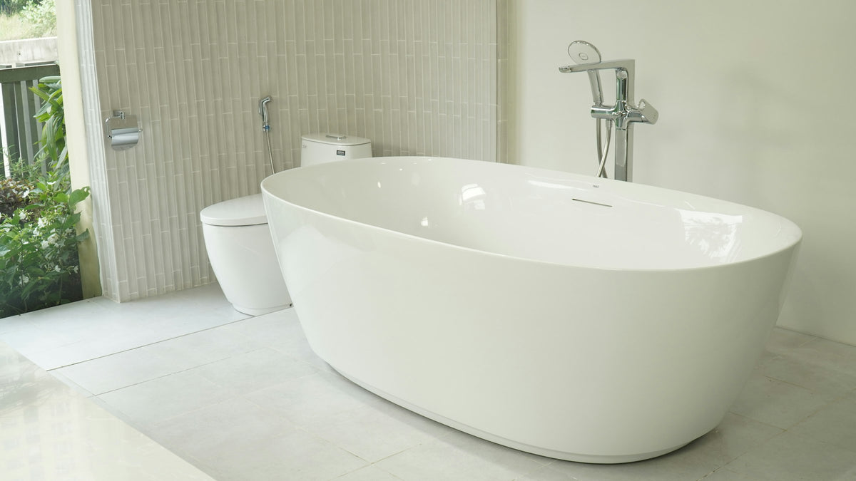 Freestanding bathtub near a window