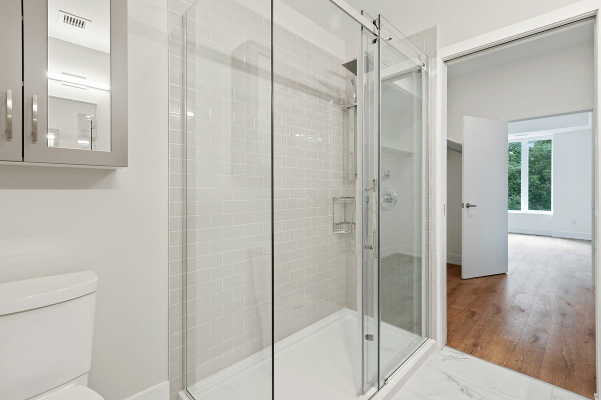 Glass shower door with a white frame