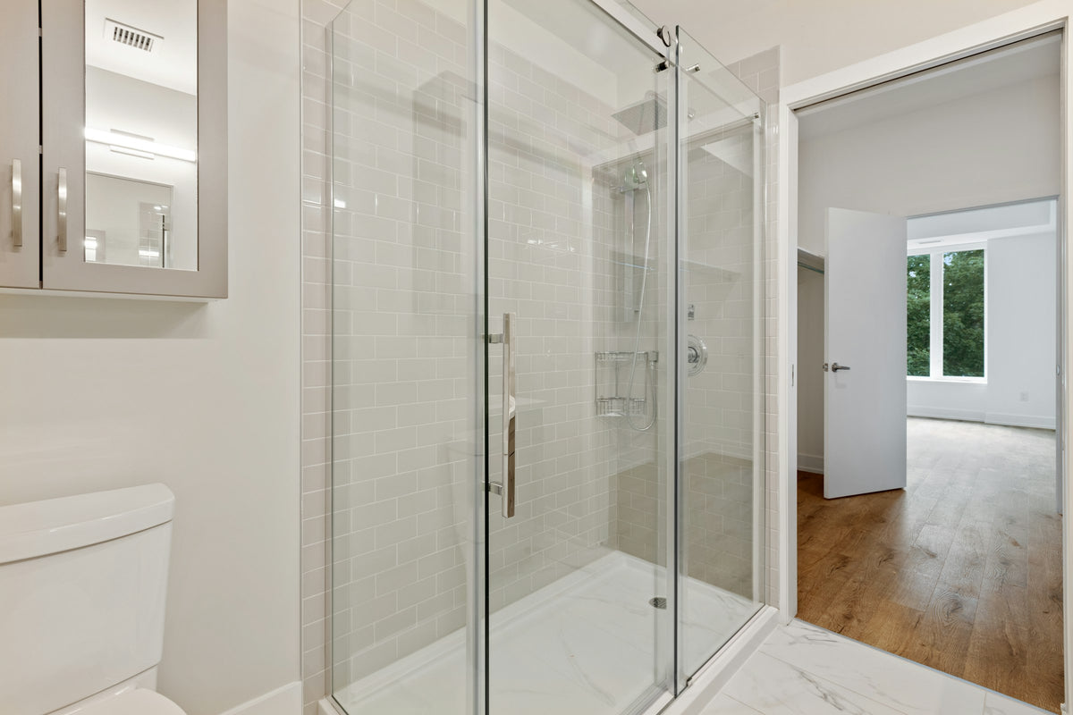 Glass shower enclosure with a steel frame