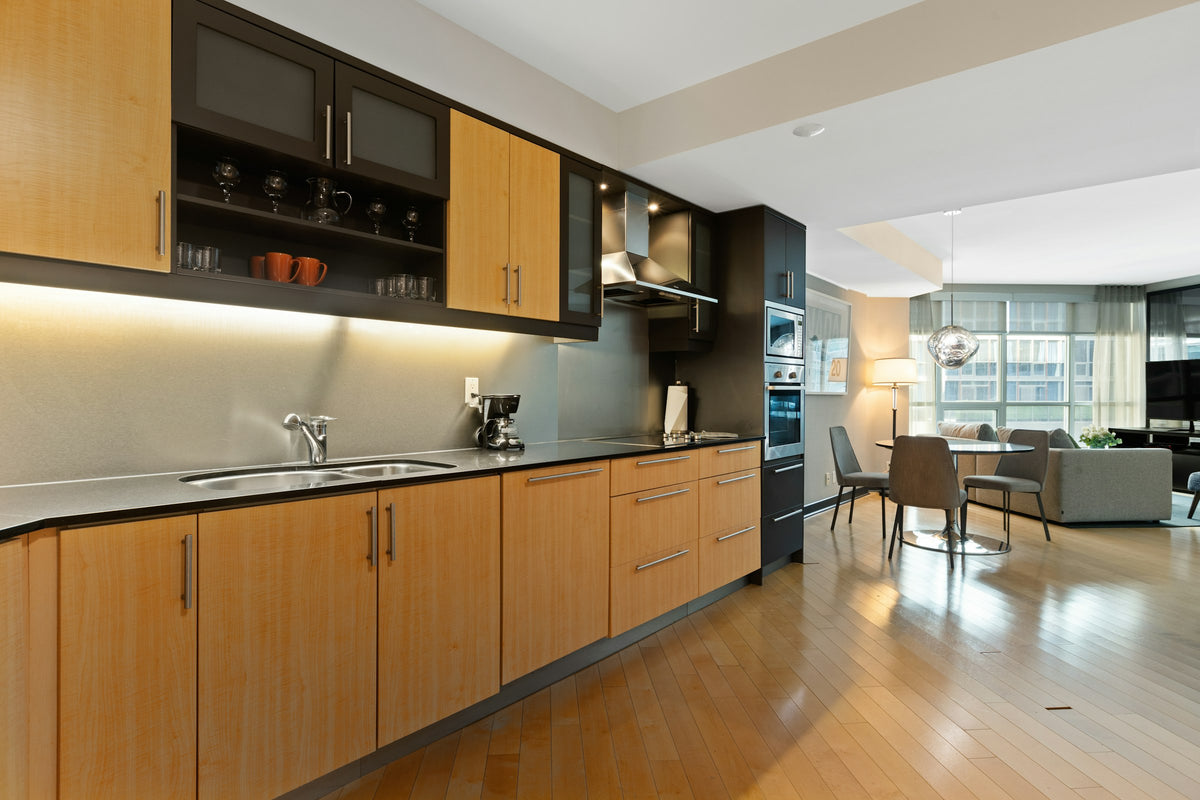 Wood kitchen cabinets around a sink