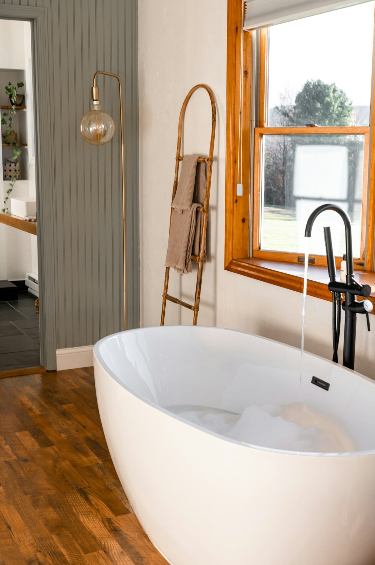 Large soaking tub next to a vanity