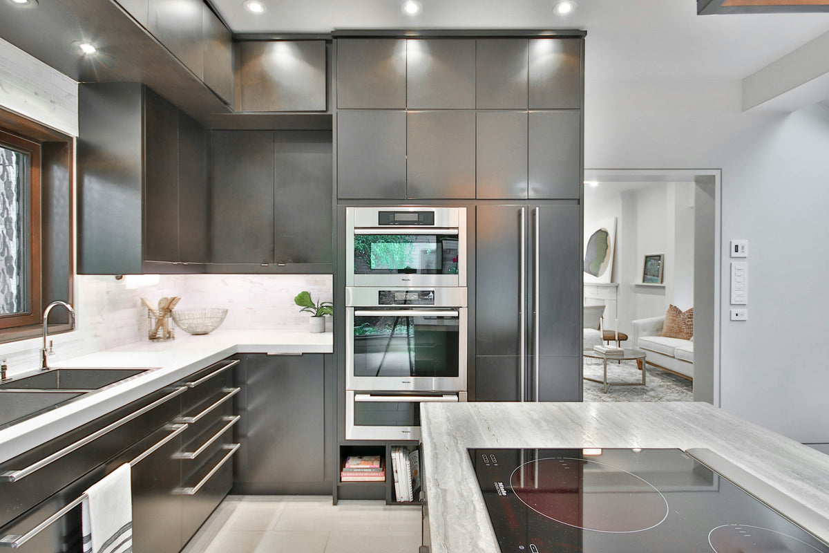 Modern kitchen with stainless appliances and marble countertops