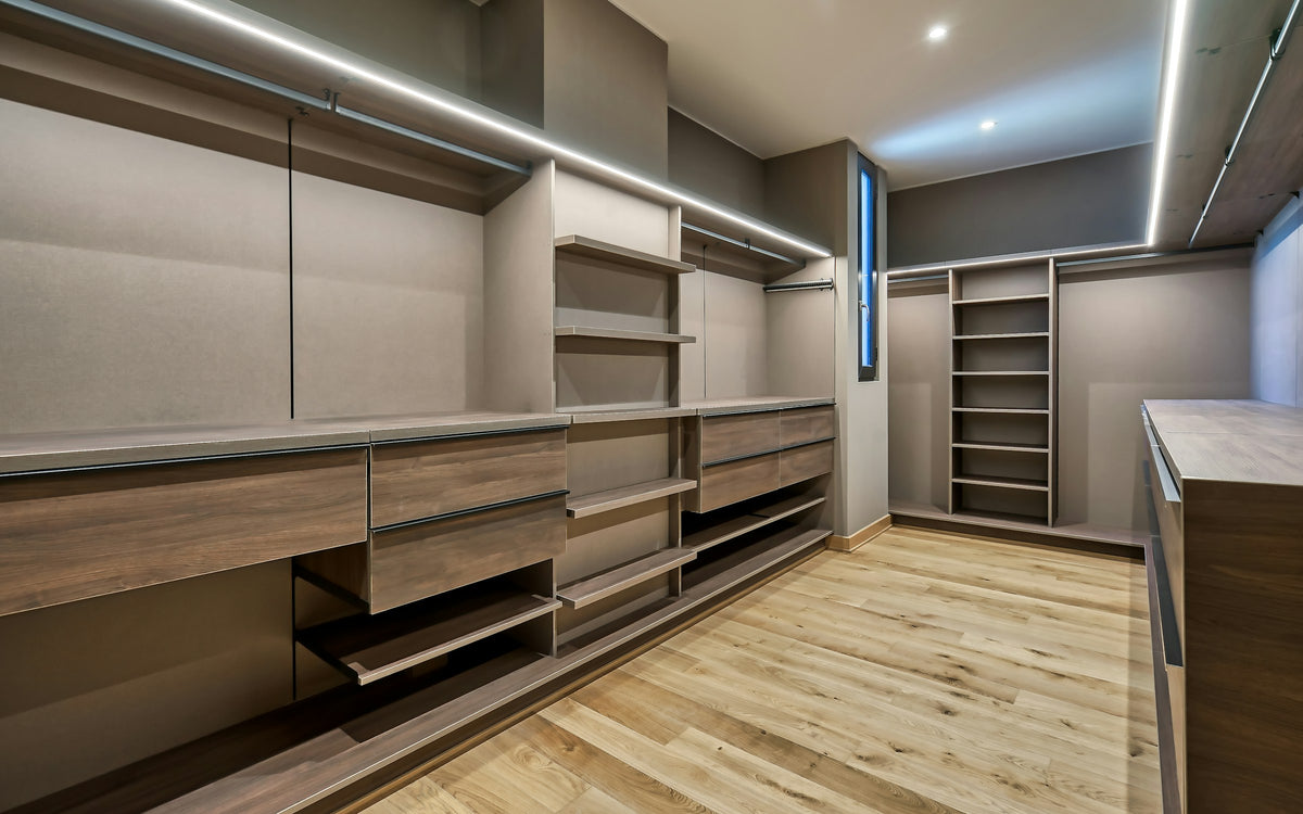 Large walk-in closet with custom shelving and hanging space