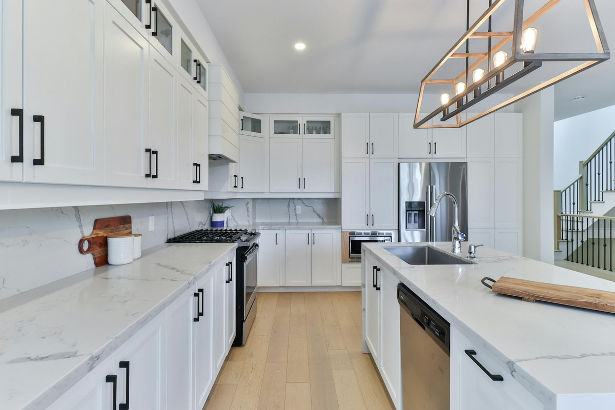 White kitchen cabinets with a wooden floor