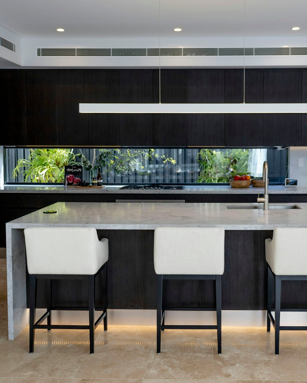 Contemporary kitchen with black custom cabinetry