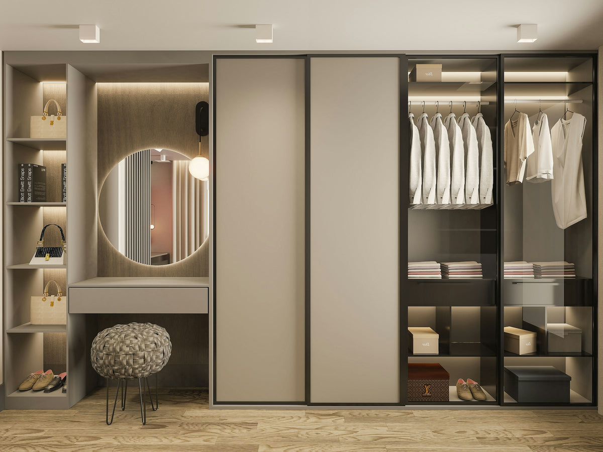 Walk-in closet with a mirror and a stool