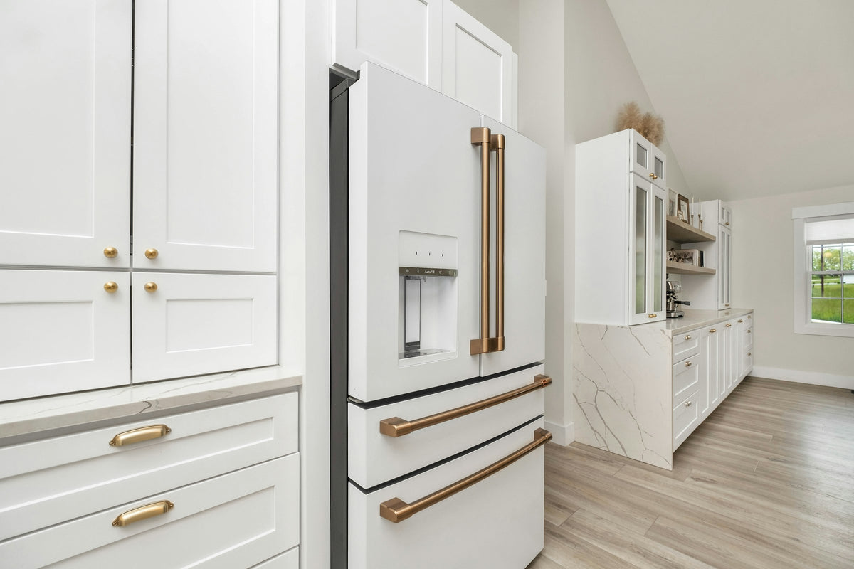 White kitchen cabinets with gold handles