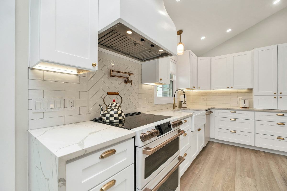 White kitchen cabinets around a range