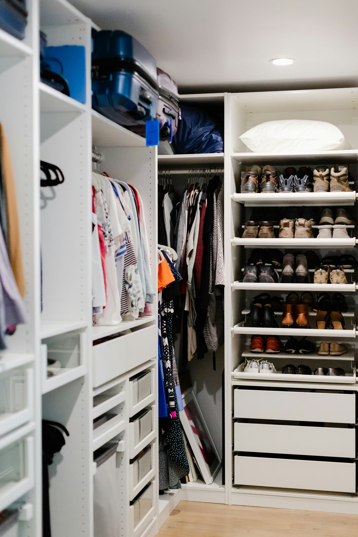 Walk-in closet with a wall of shoe shelves