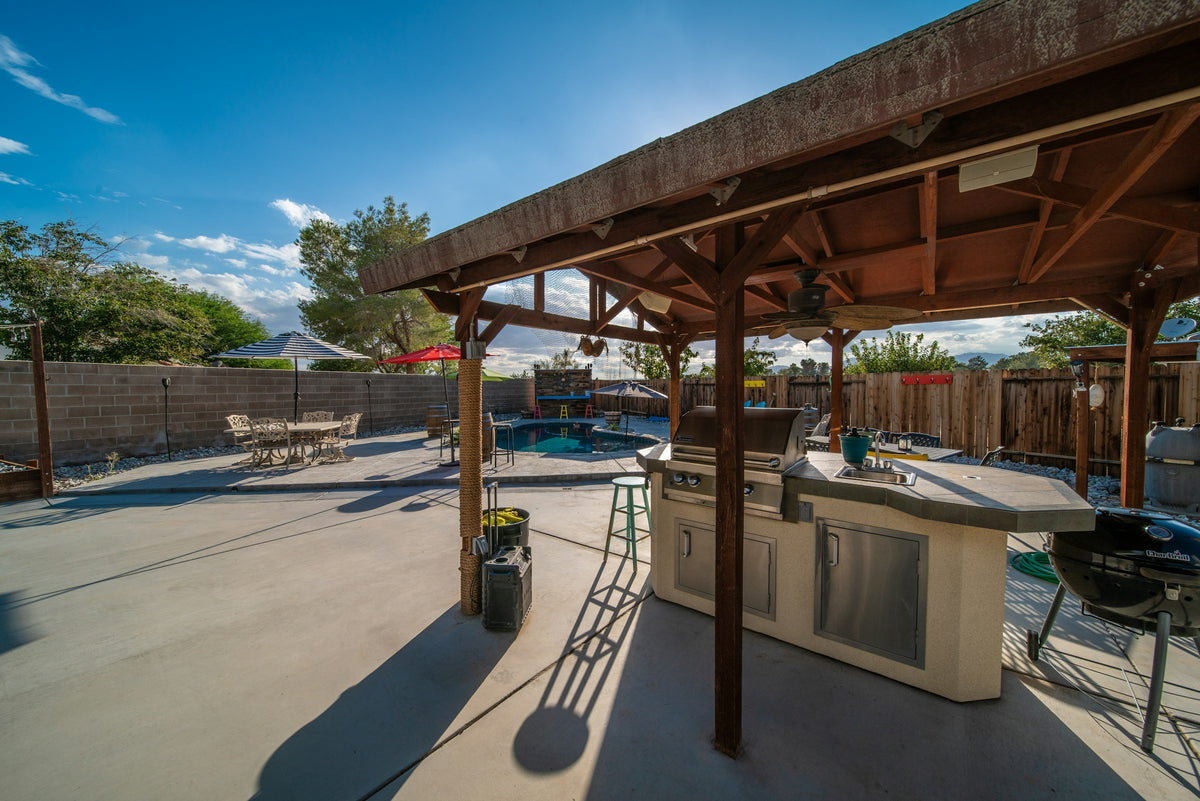 Covered patio with a grill and dining table