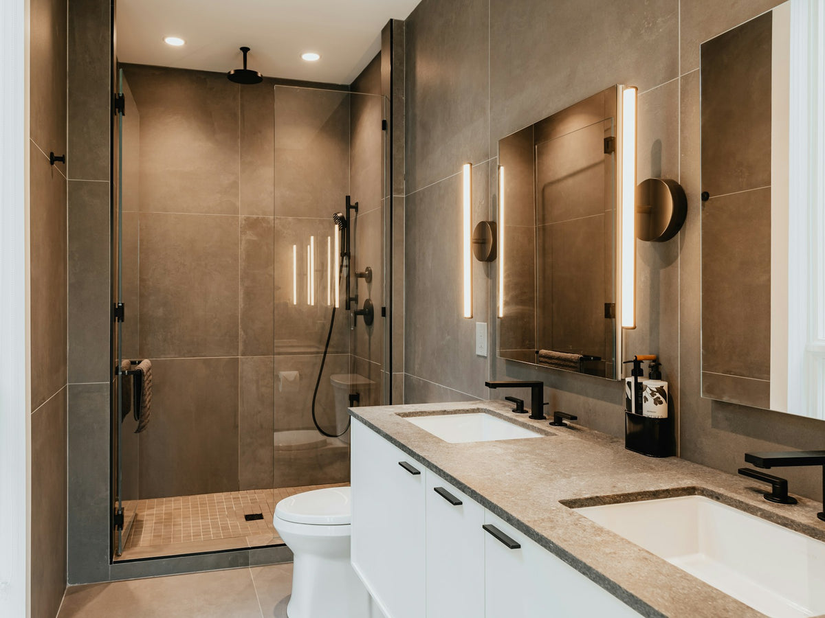 Bathroom with a double vanity and glass walk-in shower