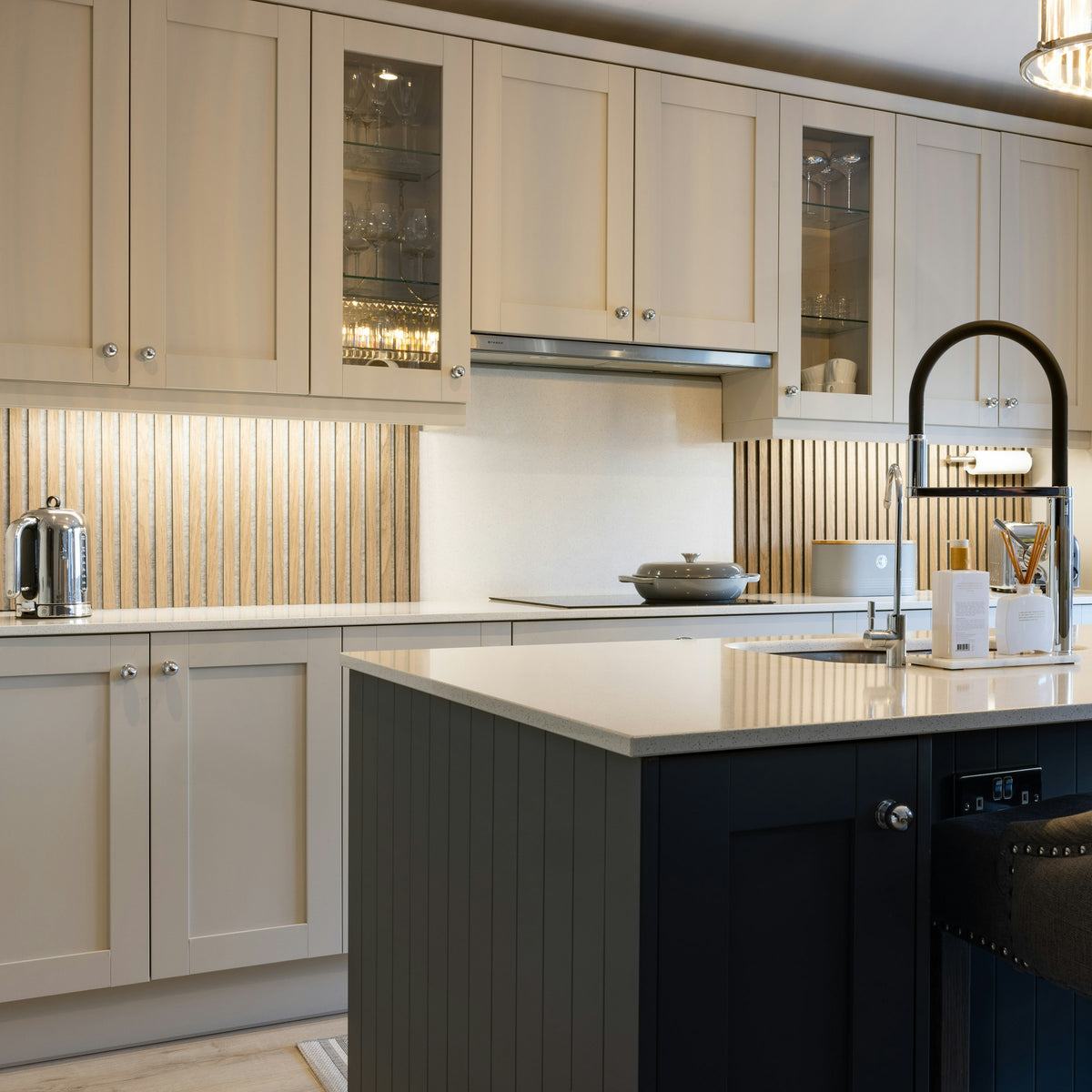 White kitchen cabinets with a black island
