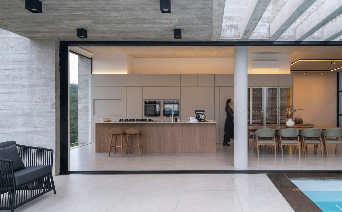 Modern kitchen and dining area opening to outdoor seating